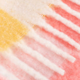 Close-up of the Maisie Check Polyester Throw in Citrus Blush, showing cream fringed edges and a woven check pattern transitioning from yellow to coral pink.
