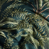 Majorelle Cotton Leaf Duvet Cover Set in green, close-up of tropical palm frond and fern print cotton fabric in deep green tones.