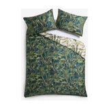 Majorelle Cotton Leaf Duvet Cover Set in green, reversible tropical palm and fern print with matching pillowcases, shown folded on a white background.
