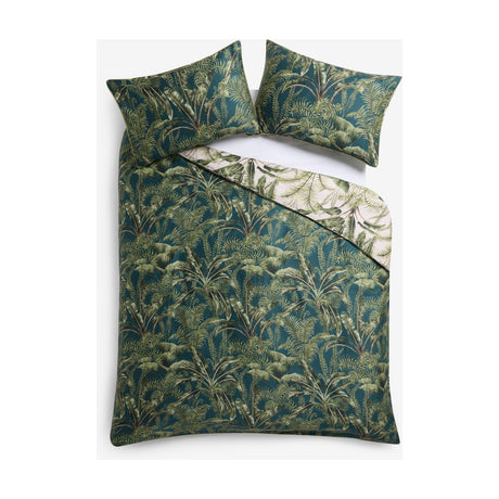 Majorelle Cotton Leaf Duvet Cover Set in green, reversible tropical palm and fern print with matching pillowcases, shown folded on a white background.