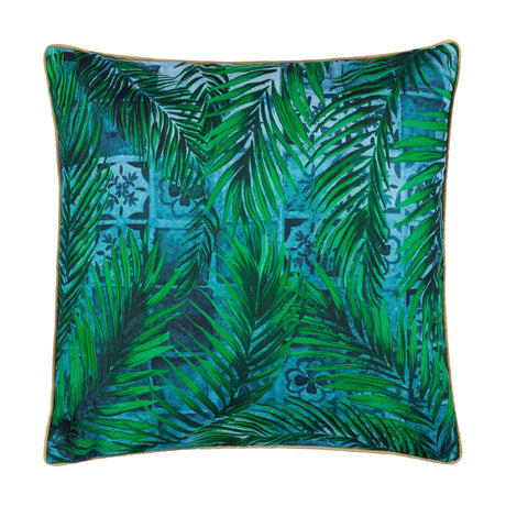 Majorelle reversible square cushion in azure, printed with green palm leaf foliage over Moroccan-style blue tilework, finished with caramel piping, shown on a white background.