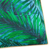 Close-up of the Majorelle Reversible Polyester Cushion in Azure, showing green palm leaf print over a blue tiled pattern with tan piping along the edge.