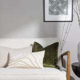 Malans Geometric Velvet Cushion in olive with cracked-line pattern, styled on a boucle sofa alongside a cream patterned lumbar cushion.