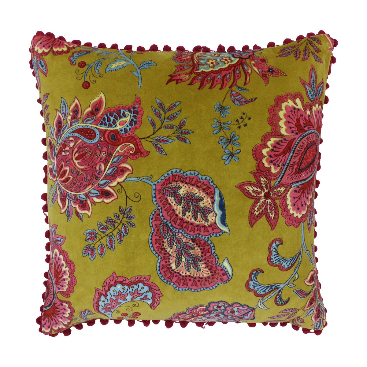 Malisa Velvet Cotton Cushion in Lemon Curry, a square mustard-yellow cover with pink, red and blue paisley floral print and red pom-pom trim, shown on a white background.
