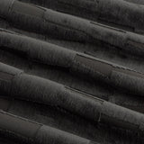 Close-up of Manhattan Velvet Fully Lined Eyelet Curtains in charcoal, showing cut-pile velvet fabric with a textured geometric block pattern and soft fold detail.