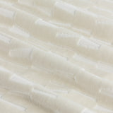 Close-up of the Manhattan ivory eyelet curtain fabric, showing cut velvet with a textured geometric block pattern raised against a smooth polyester ground.
