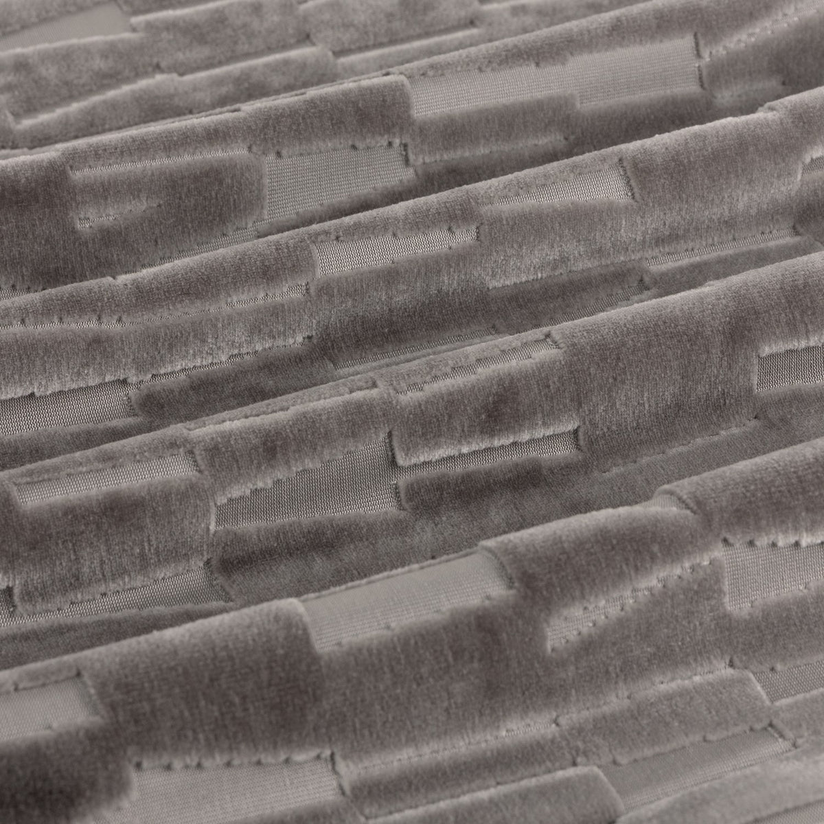 Close-up of Manhattan velvet eyelet curtain fabric in mink brown, showing a cut-velvet textured geometric tile pattern with visible stitched grid lines.