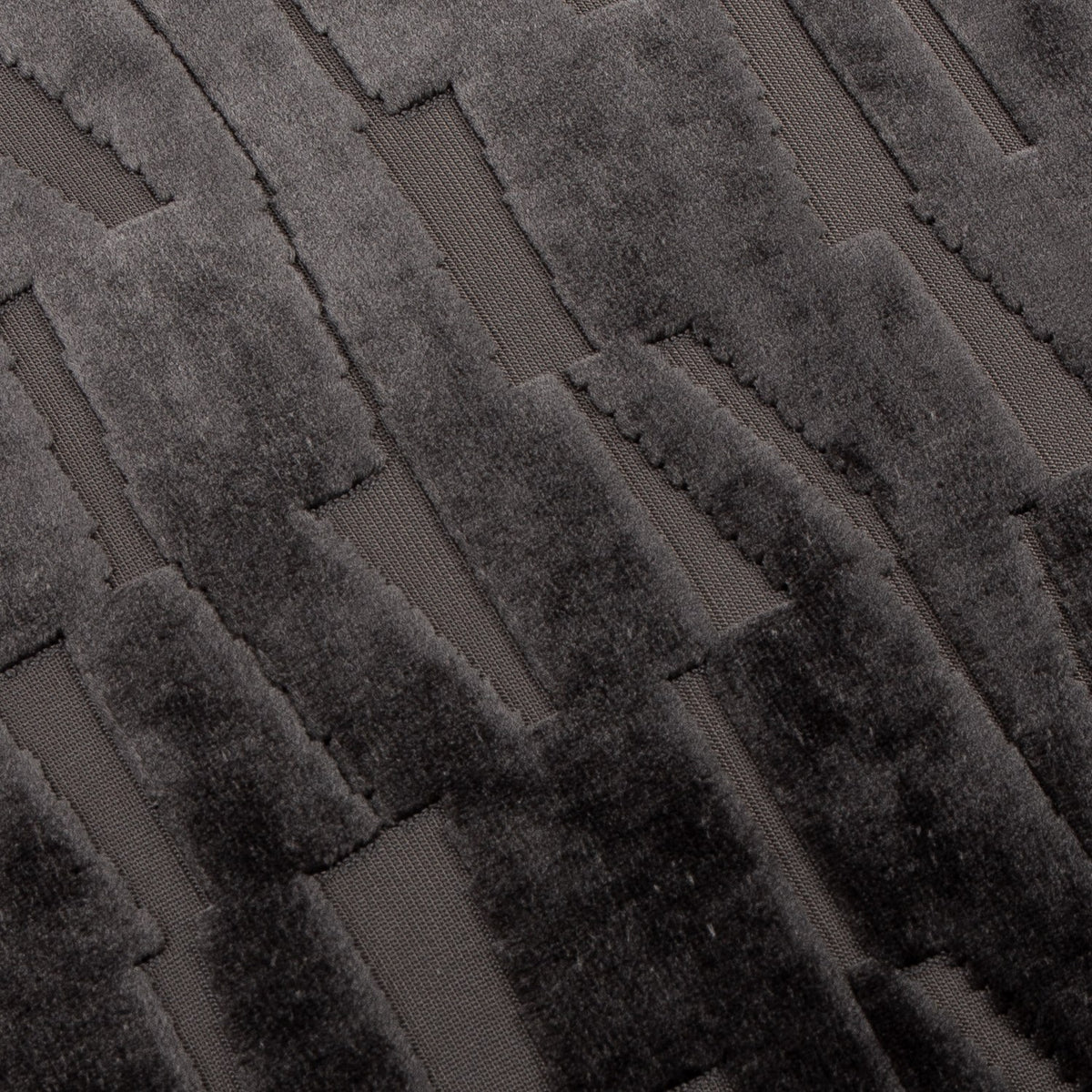 Close-up of the Manhattan Geometric Velvet Cushion in charcoal, showing cut-velvet vertical bars in raised pile against a flatter woven ground.