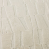 Close-up of the Manhattan Geometric Velvet Cushion in ivory, showing cut-velvet pile with angled blocks forming an irregular brickwork pattern.