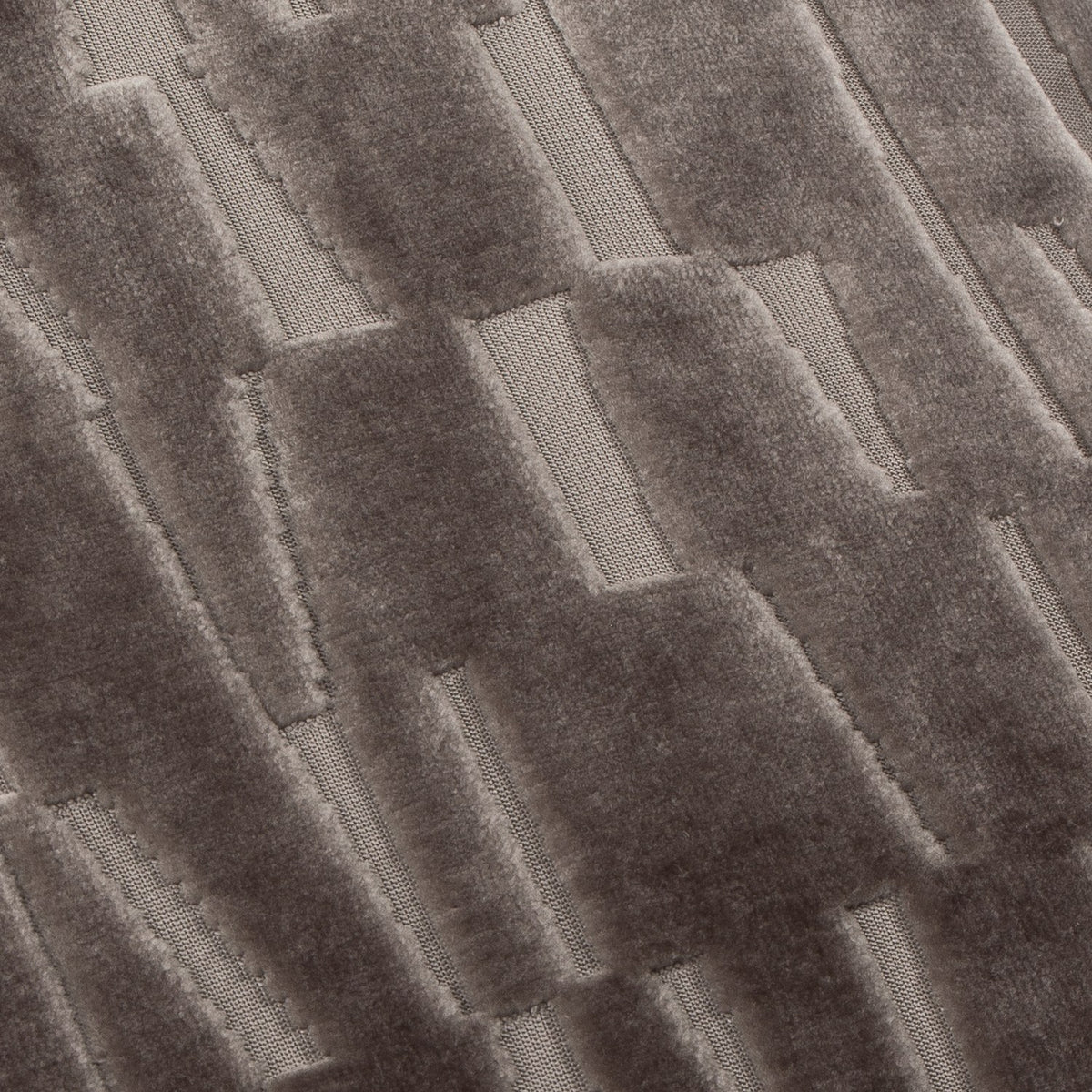 Manhattan Geometric Velvet Cushion in mink, close-up of cut-velvet pile forming staggered rectangular blocks with contrasting sheen against a smoother woven ground.