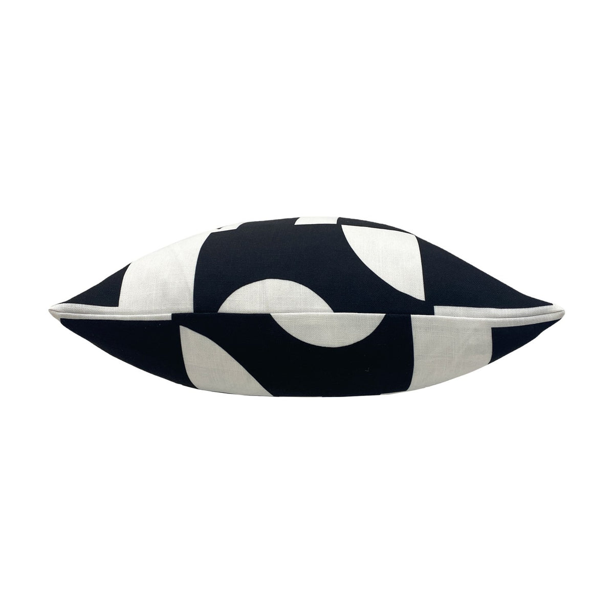 Manhattan Abstract Polyester Cushion in Mono, shown side-on with black and white geometric print and white piped edge, on a plain white background.