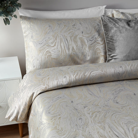 Marble Jacquard Abstract Duvet Cover Set in Oyster with swirling metallic-look pattern, styled with matching pillowcases and a grey textured cushion on a bed.