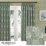 Marigold Jacquard pencil pleat curtains in leaf green, shown as a lined pair with 5-inch pencil pleat heading framing a French door in a living room, with matching fabric swatch.