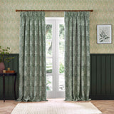Marigold Jacquard pencil pleat curtains in leaf green, hung either side of a French door, showing woven foliage and floral pattern with 5-inch pencil pleat heading.