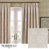 Marigold Jacquard Polyester pencil pleat curtains in stone, shown pleated on a wooden pole at a window, with a fabric swatch inset showing the raised floral jacquard weave.