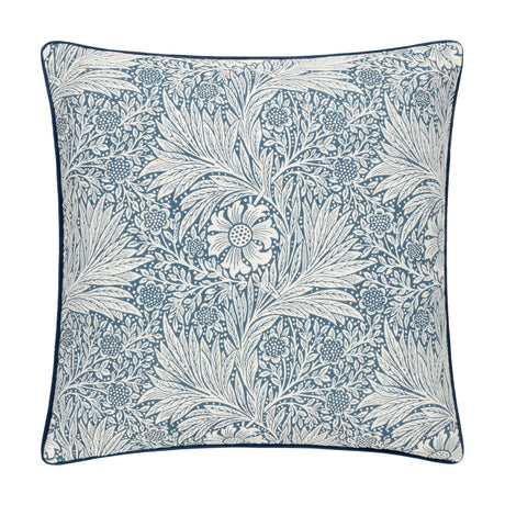 Square cushion in indigo blue jacquard velvet with a cream Marigold floral and foliage pattern by William Morris, finished with matching piped edging, shown on a plain white background.