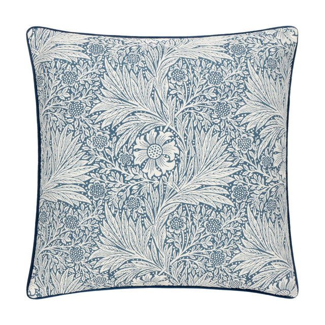 Square cushion in indigo blue jacquard velvet with a cream Marigold floral and foliage pattern by William Morris, finished with matching piped edging, shown on a plain white background.