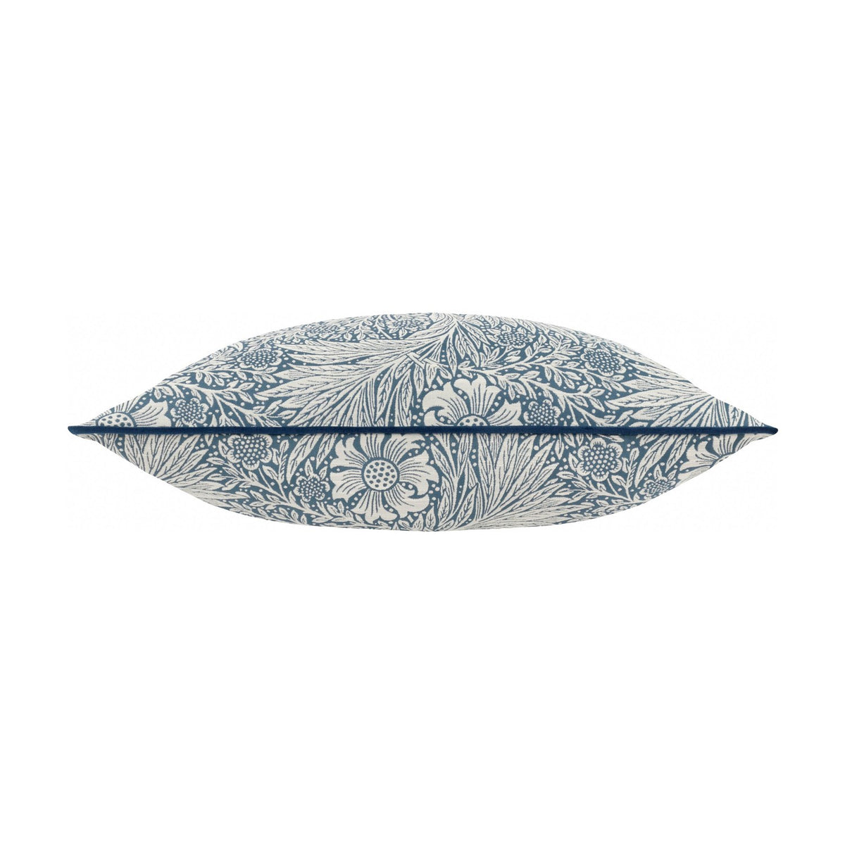 Marigold Jacquard Velvet Cushion in indigo, shown side-on to reveal its plump shape, with cream marigold and foliage pattern wrapping the edges against a white background.