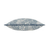 Marigold Jacquard Velvet Cushion in indigo, shown side-on to reveal its plump shape, with cream marigold and foliage pattern wrapping the edges against a white background.