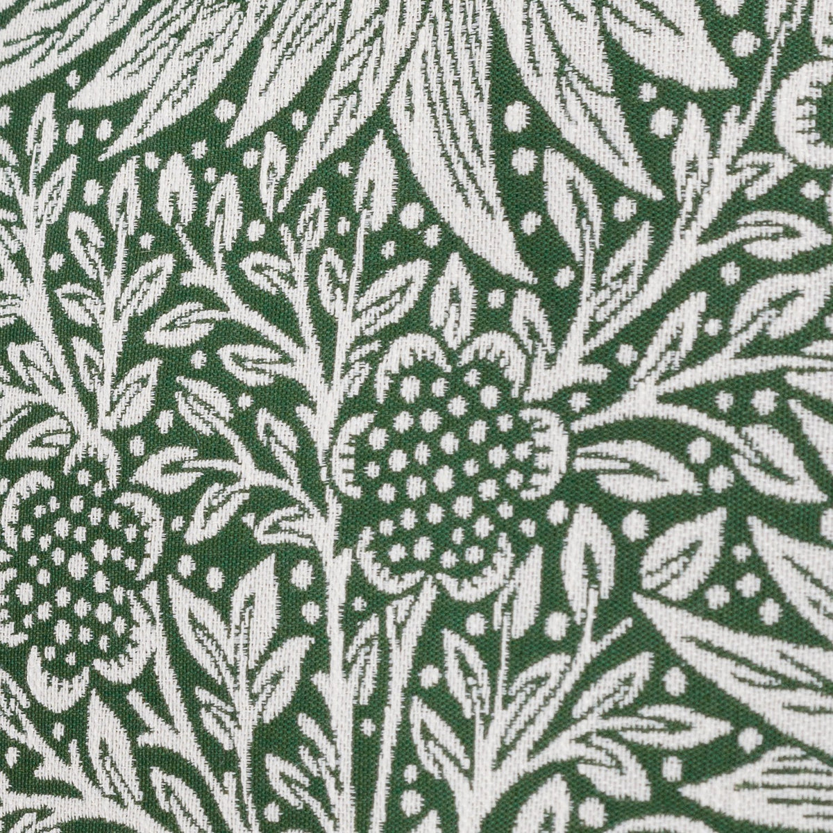 Close-up of the Marigold Jacquard Velvet Cushion in Leaf Green, showing a woven floral and foliage pattern in white against a deep green ground with raised jacquard texture.