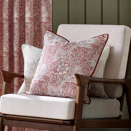 Marigold Jacquard Velvet Cushion in Russet with cream floral pattern, piped edge, styled on an armchair alongside matching curtains.