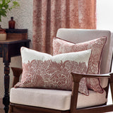 Marigold Jacquard Velvet Cushions in russet with cream William Morris floral pattern, shown on a chair with a matching cushion and floral curtain in the background.