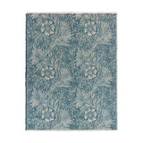 Marigold Jacquard Cotton Throw in indigo blue, showing a woven floral and leaf pattern with fringed edges, laid flat on a plain white background.