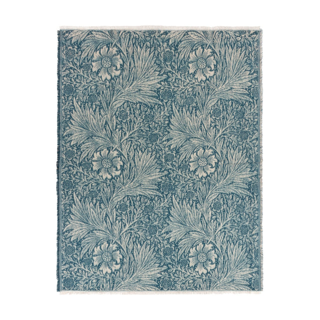 Marigold Jacquard Cotton Throw in indigo blue, showing a woven floral and leaf pattern with fringed edges, laid flat on a plain white background.