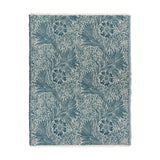 Marigold Jacquard Cotton Throw in indigo, a woven blue and cream botanical floral pattern with fringed edges, shown on a plain white background.