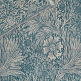 Marigold Jacquard Cotton Throw in indigo, close-up of the woven floral and leaf pattern with a fringed edge, showing the reverse cream-toned design beneath.