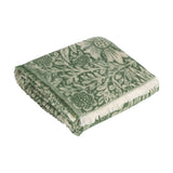 Marigold Jacquard Cotton Throw in Leaf Green, folded showing William Morris floral pattern in green and cream with fringed edge, on a plain white background.