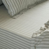 Marlow Stripe Printed Cotton Fitted Sheet in Artichoke/Sage, showing a green and white striped cotton bed sheet with matching pillowcase and elasticated corner detail.