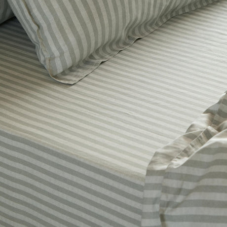 Marlow Stripe Printed Cotton Fitted Sheet in Artichoke/Sage, showing a green and white striped cotton bed sheet with matching pillowcase and elasticated corner detail.