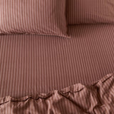 Marlow Stripe Printed Cotton Fitted Sheet in chocolate/rosewood, shown on a bed with matching striped pillowcases, fine tonal stripe pattern and elasticated corners visible.