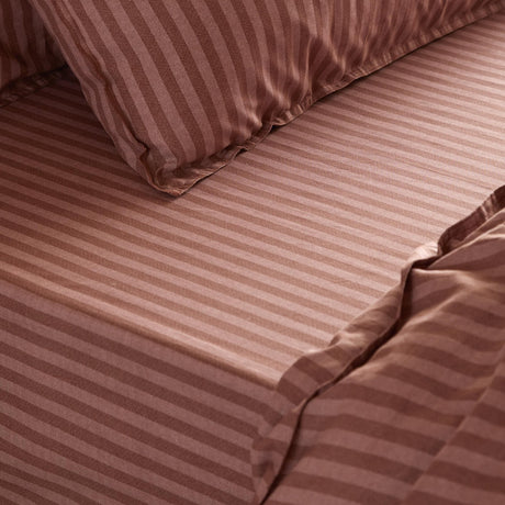 Marlow Stripe Printed Cotton Fitted Sheet in Chocolate/Rosewood, shown fitted to a mattress with matching pillowcase, in a tonal striped cotton finish.