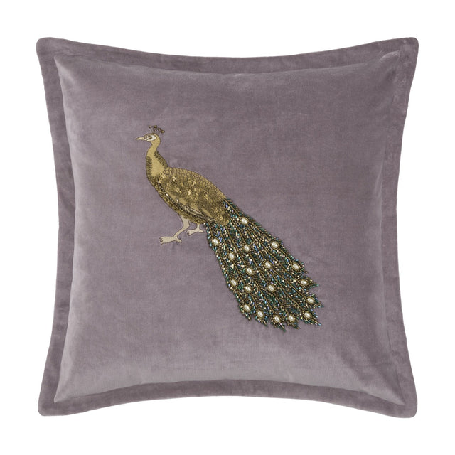 Mayura Animal Velvet Cushion in lavender, square with flanged edge, featuring an embroidered gold-thread peacock with a beaded green, bronze and pearl-white tail, shown on a plain white background.