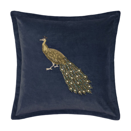 Mayura Animal Velvet Cushion in Midnight blue, featuring an embroidered gold peacock with a beaded tail in green and bronze tones, shown on a plain white background.
