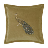 Mayura square velvet cushion in mustard-gold with a hand-embroidered peacock design featuring beaded body, tail, and legs, shown on a plain white background.