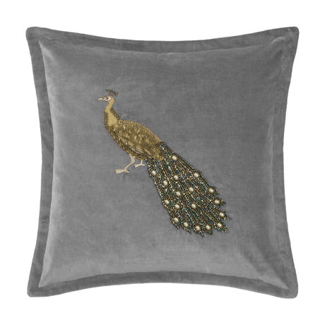 Mayura Animal Velvet Cushion in steel grey with a beaded peacock design, gold body and jewelled bugle-bead tail, square shape, on a white background.