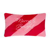 Rectangular faux fur cushion in diagonal red and pink stripes with "Merry & Bright" embroidered in white script across the plush pile front, shown on a plain white background.