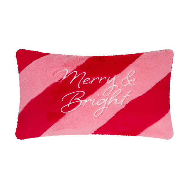 Rectangular faux fur cushion in diagonal red and pink stripes with "Merry & Bright" embroidered in white script across the plush pile front, shown on a plain white background.