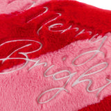 Close-up of the Merry & Bright Striped Faux Fur Cushion in red and pink, showing raised script embroidery on plush diagonal-striped pile fabric.