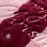 Close-up of the Merry Christmas Plain Faux Fur Cushion in burgundy and pink, showing plush pile fabric with embroidered lettering and star details.