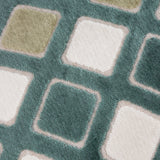 Metro Diamond Jacquard Velvet Cushion in green, close-up showing woven diamond pattern with sage, cream and white squares on a teal-green velvet ground.