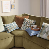 Metro Diamond Jacquard Velvet Cushion in green, teal, orange and cream diamond pattern, styled on an olive velvet sofa with patterned and plain cushions.