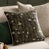 Meadow Bloom Floral Chenille Cushion in multicolour, square with piped edge, featuring a dense floral and bee print on a near-black ground, styled on a living room sofa.