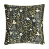 Square multicolour chenille cushion with pale green piping, featuring a dense botanical print of leaves, daisies, bees and sage buds on a near-black ground.