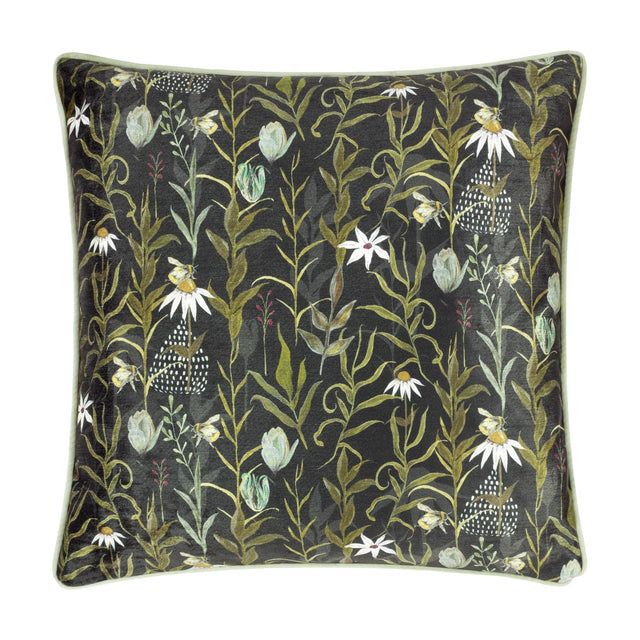 Square multicolour chenille cushion with pale green piping, featuring a dense botanical print of leaves, daisies, bees and sage buds on a near-black ground.