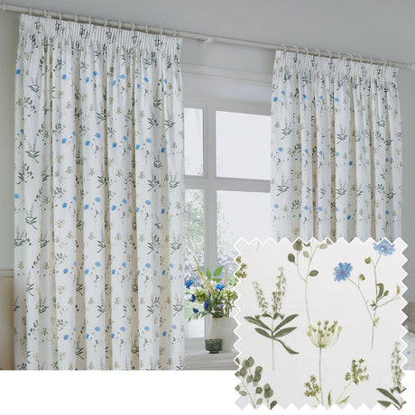 Meadow Floral Cotton Pencil Pleat Curtains in white with a scattered cornflower-blue and green floral print, shown hanging at a window, with a fabric swatch inset.