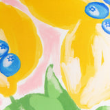 Close-up of the Mediterranean Limon reversible polyester cushion fabric, showing a hand-painted lemon print with blueberries and green leaves on a yellow and pink ground.